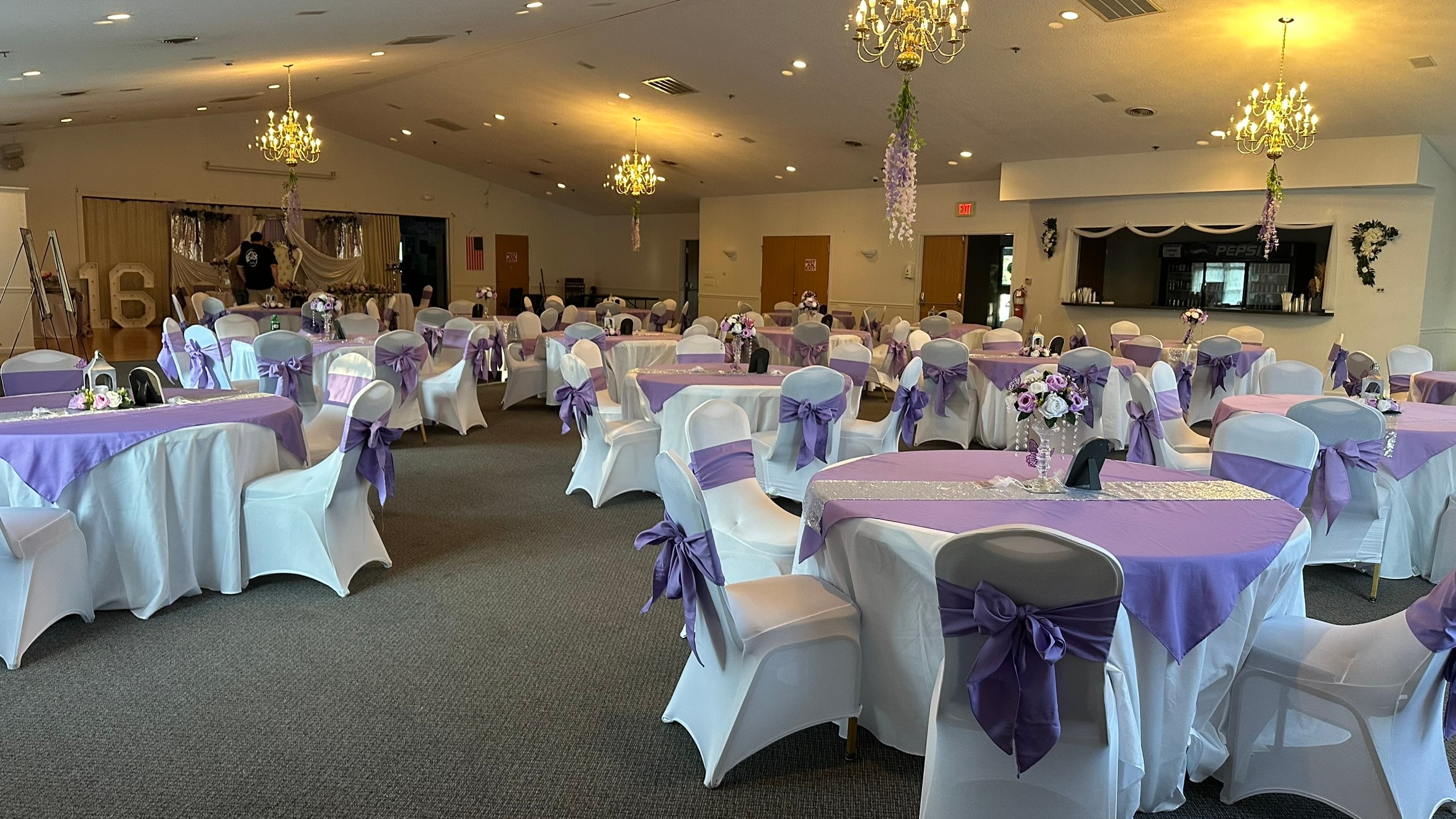 Watertown Elks Lodge banquet room set for a celebration with purple chair sashes and chandeliers