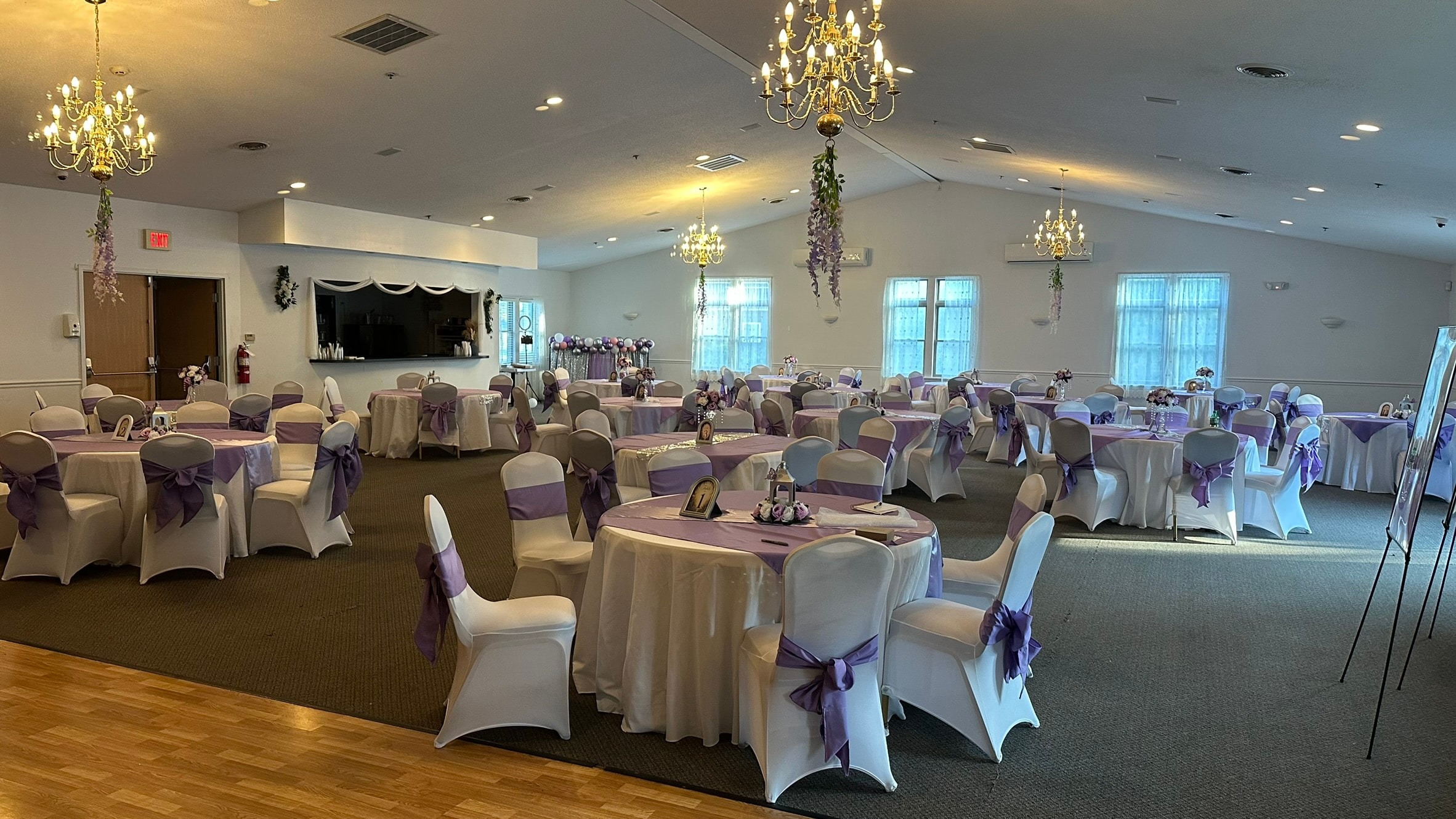 Watertown Elks Lodge banquet room with purple linens and chandelier lighting