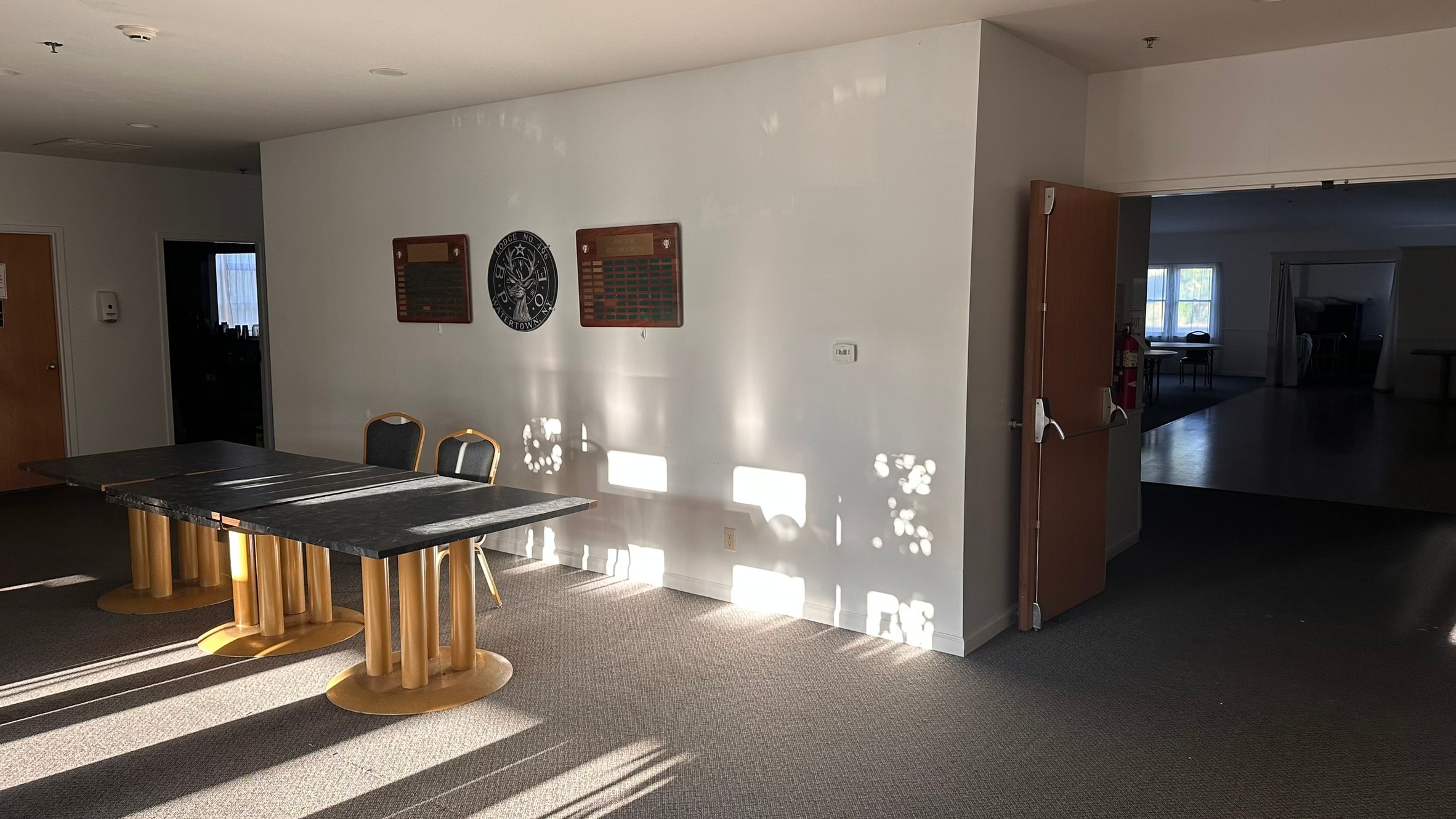 Main entrance foyer of the Watertown Elks Lodge with lodge plaques and view into the banquet room