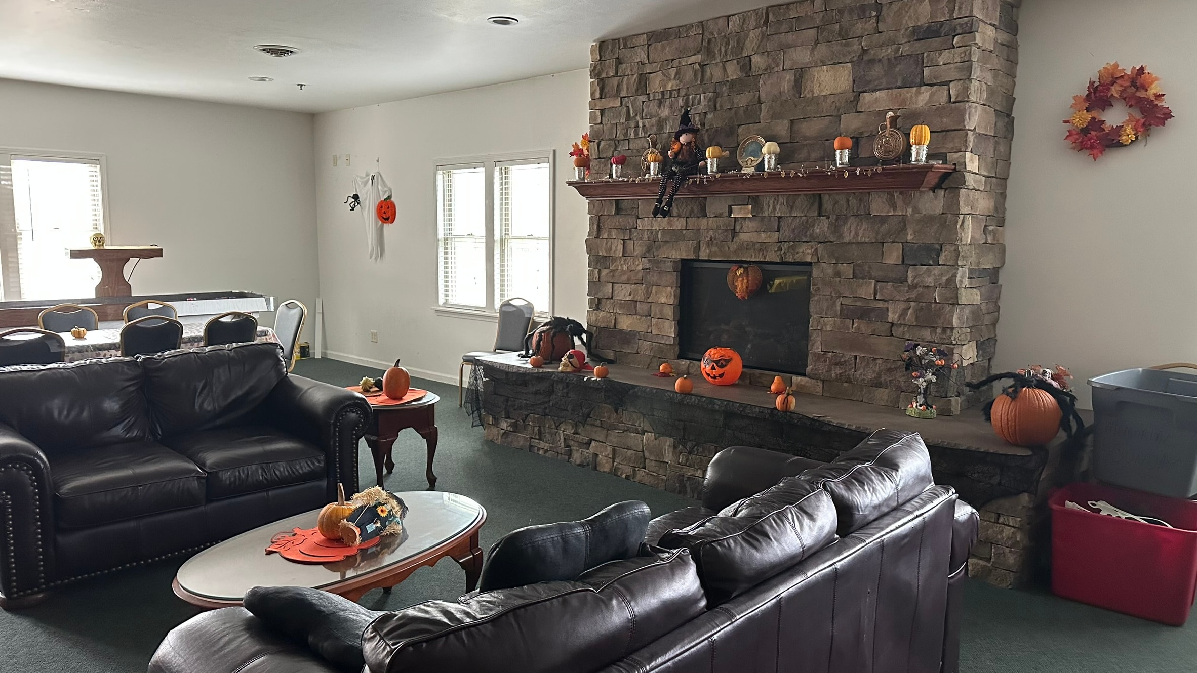 Paul K. Majo Memorial Fireplace in the Watertown Elks Lodge game room with stone surround and leather seating