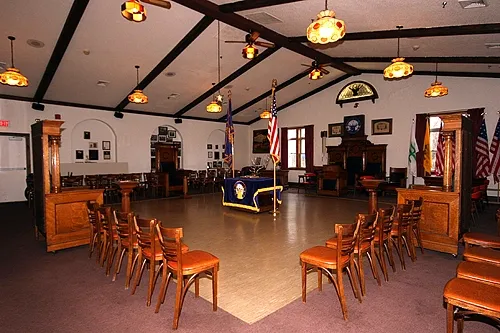 Watertown Elks Lodge meeting room set for a formal lodge meeting with chairs in a circle and American flags at the front